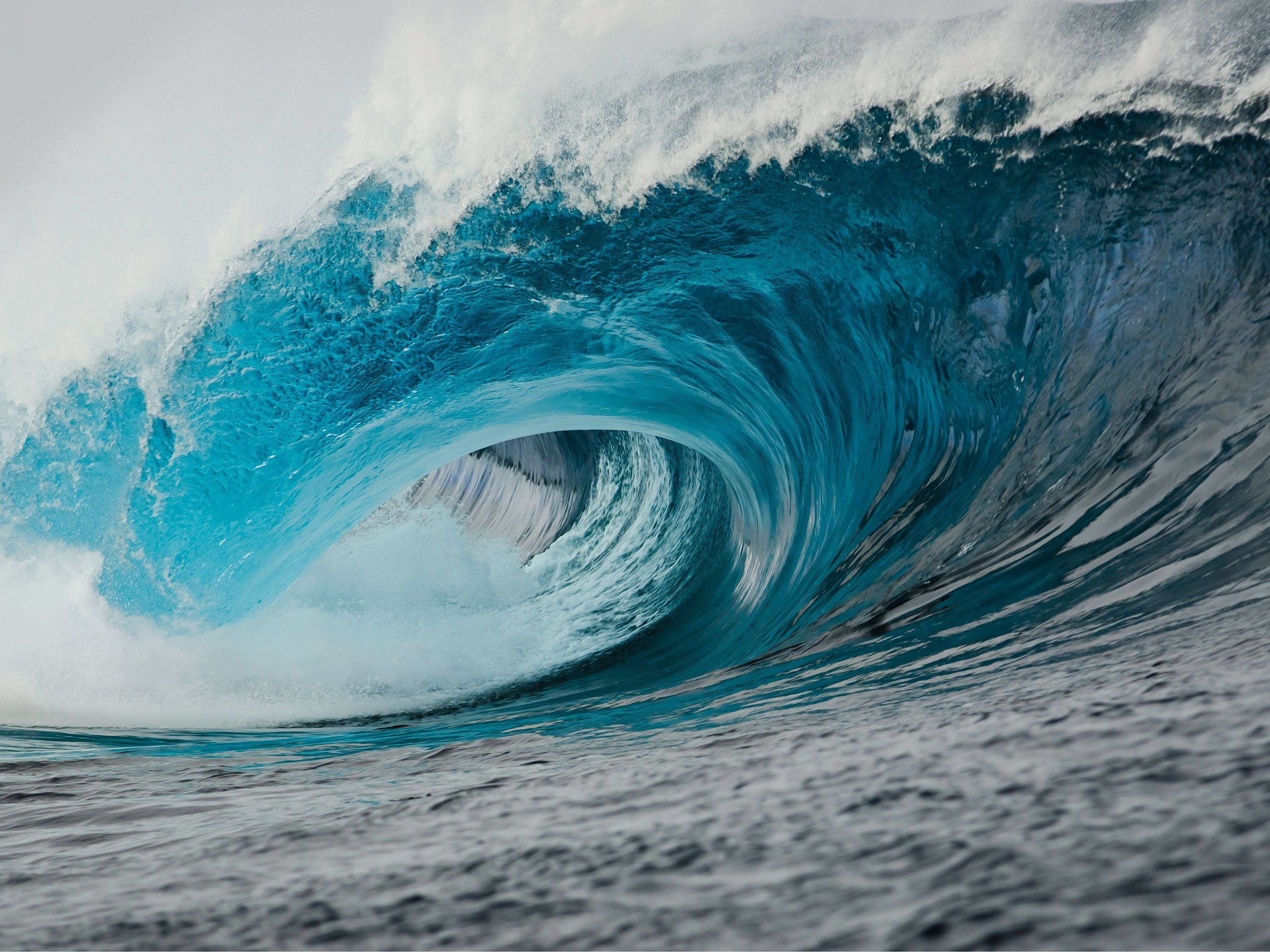 a blue wave twirling in the sea