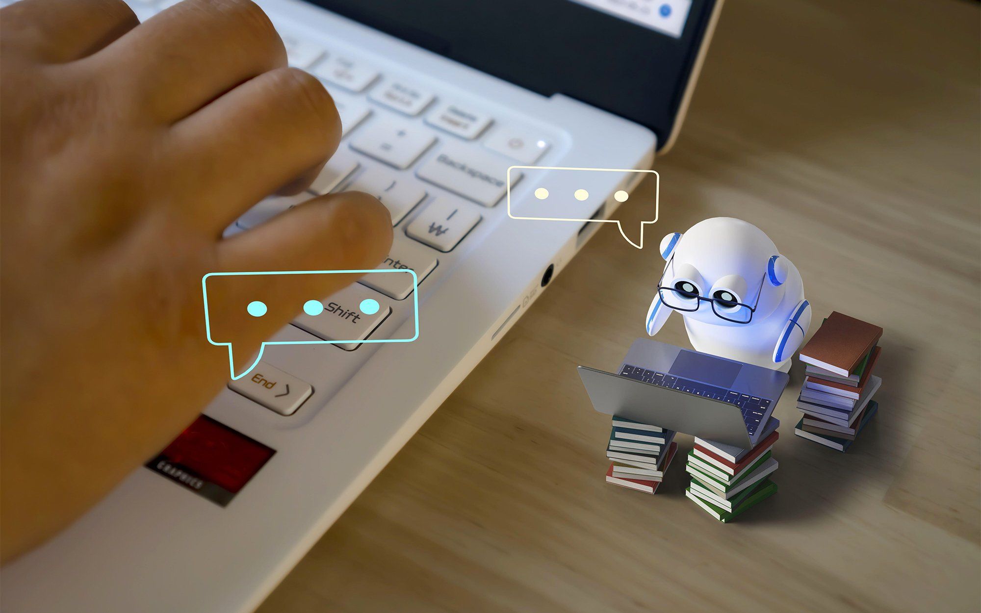 Photo-illustration of a mini AI bot looking at a laptop atop a stock of books, sitting next to human hands on a laptop.