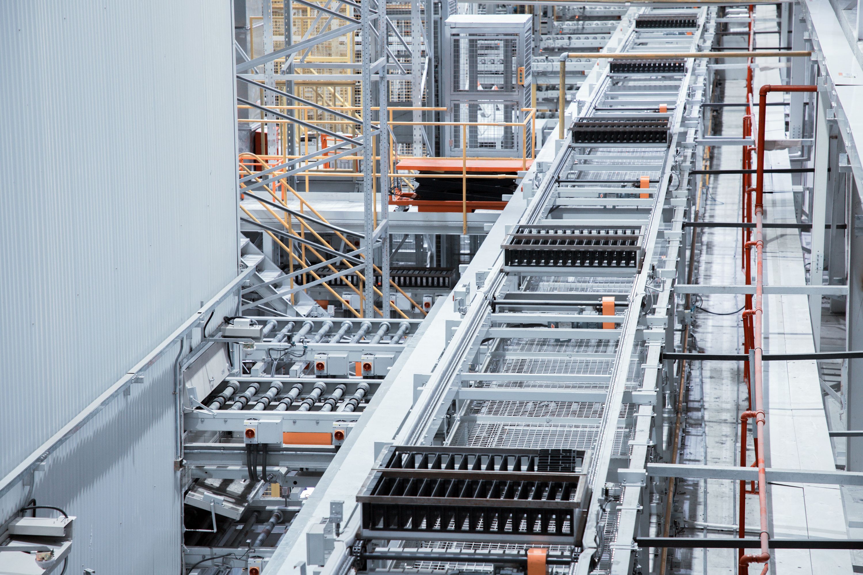 Industrial conveyor system in a large, modern manufacturing facility.