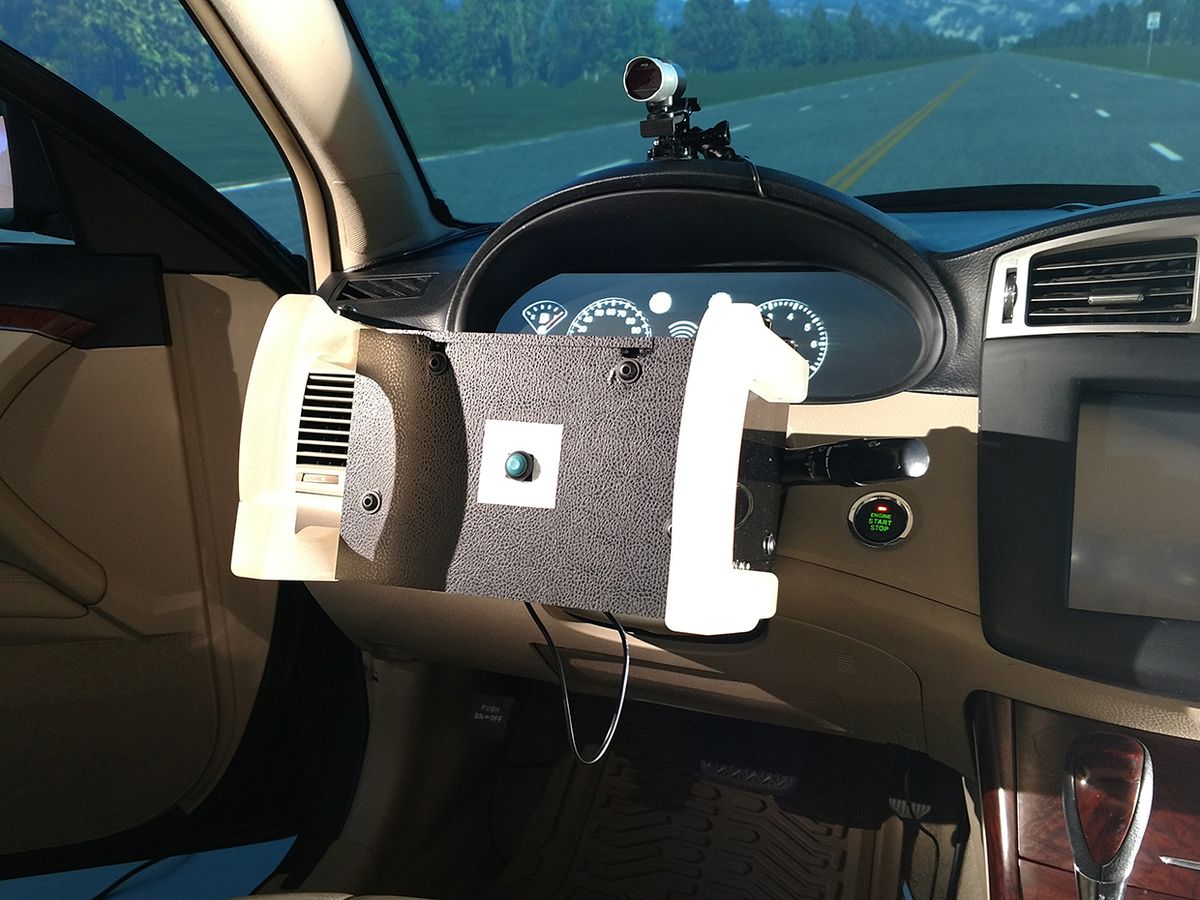 Inside of a car showing Robotic Transforming Steering Wheel