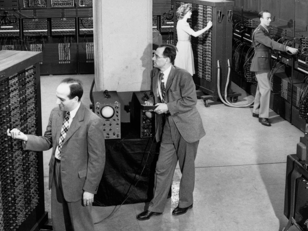 J. Presper Eckert, John Mauchley, Betty Jean Jennings, and Herman Goldstine in front of the ENIAC.