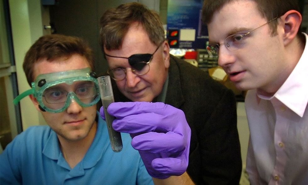 Jerry Woodall, center, and Purdue University researchers demonstrate their method for producing hydrogen by adding water to an alloy of aluminum and gallium.
