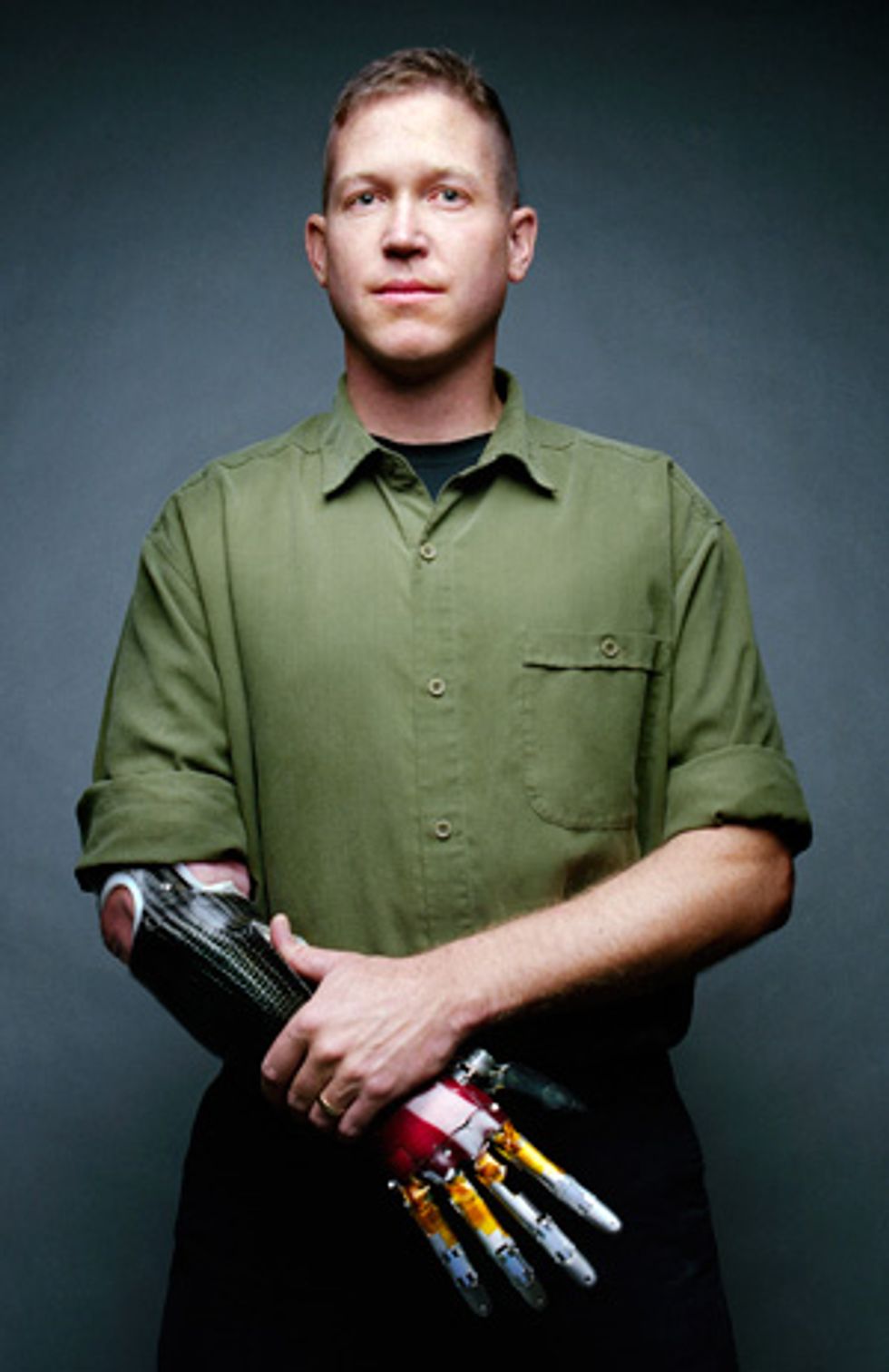Jonathan Kuniholm wears a prototype of the prosthetic arm created by DARPA