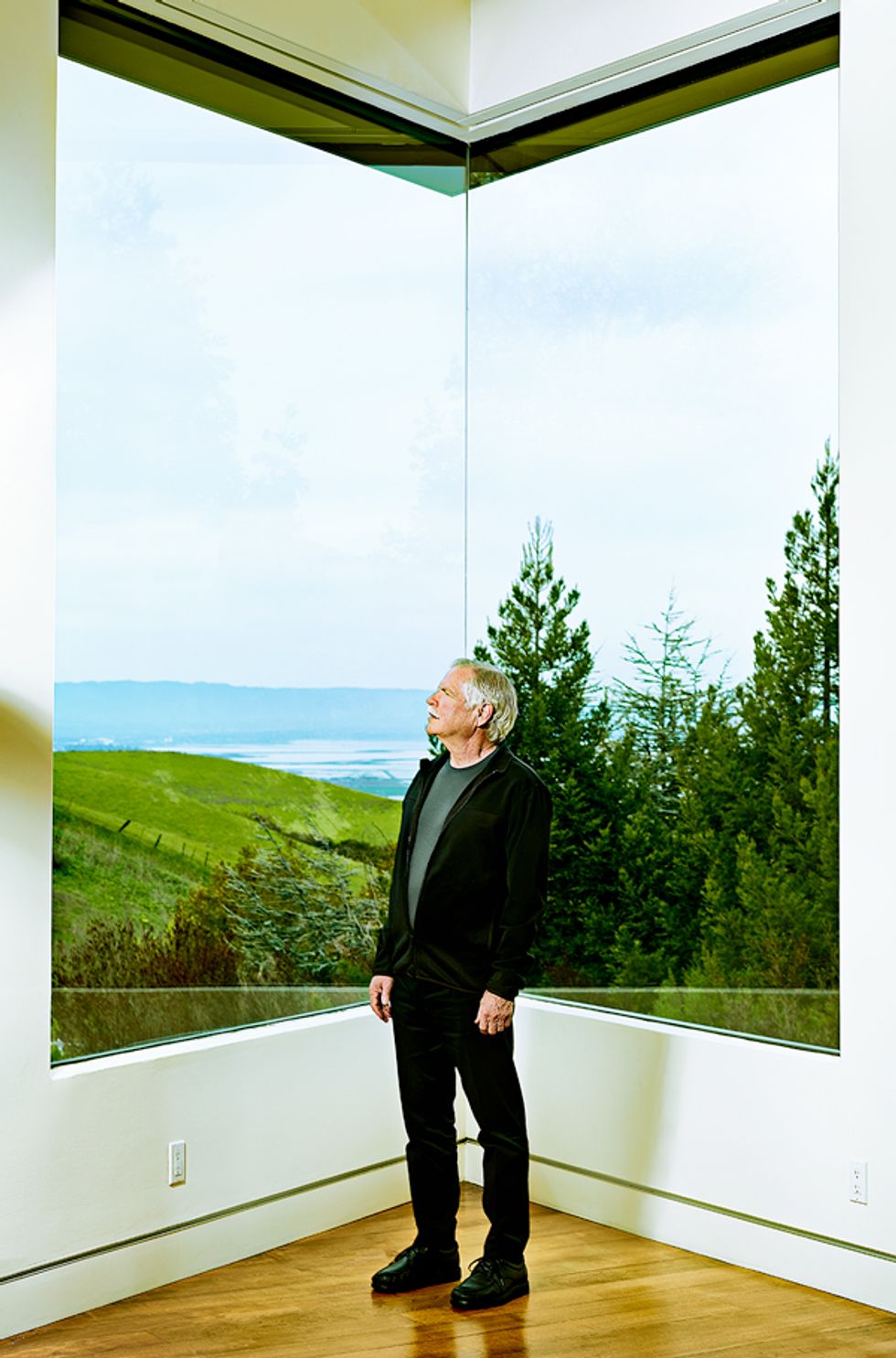 Kurt Petersen standing at a window.
