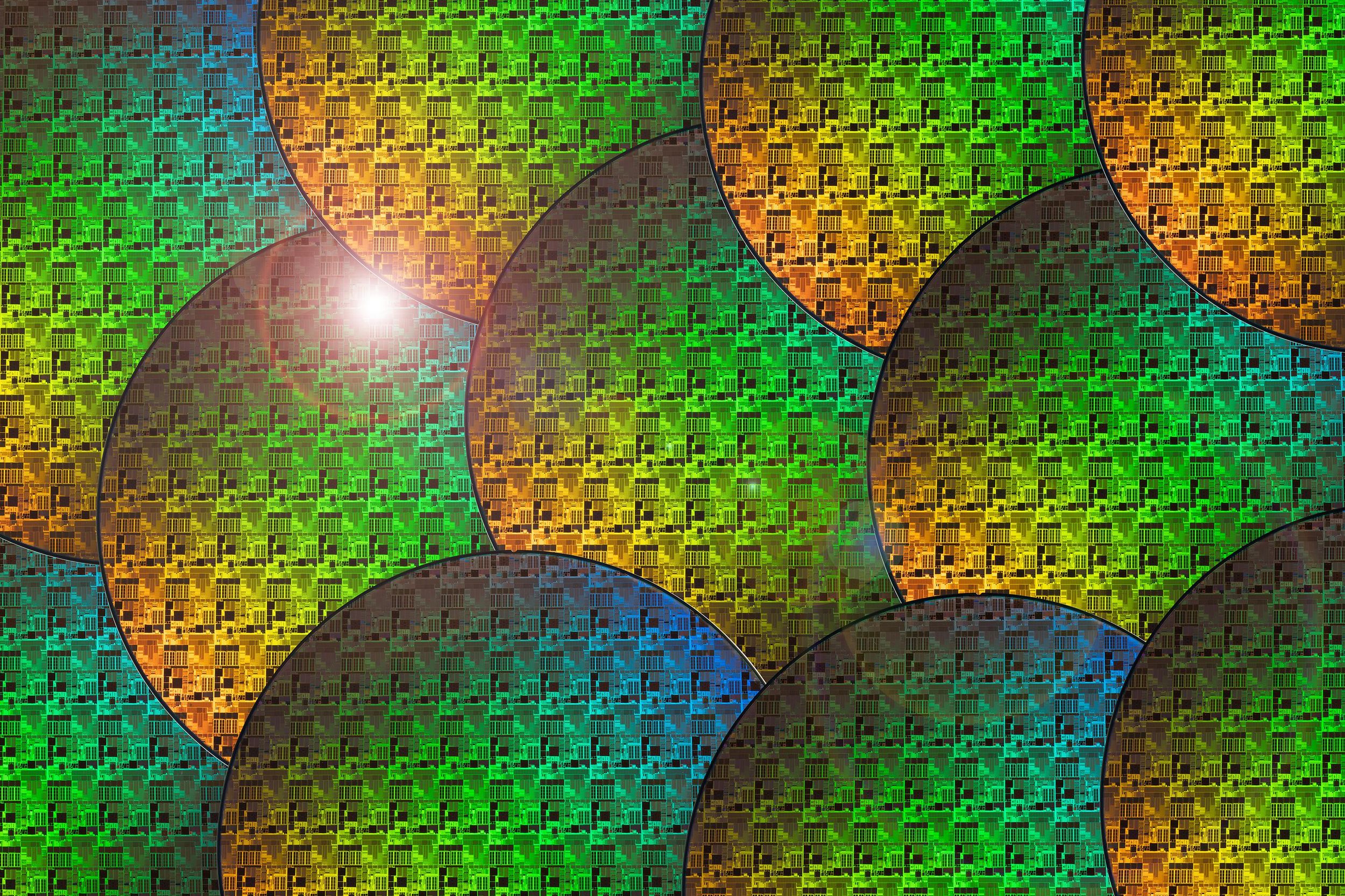 Layered rendering of colorful semiconductor wafers with a bright white light sitting on one.