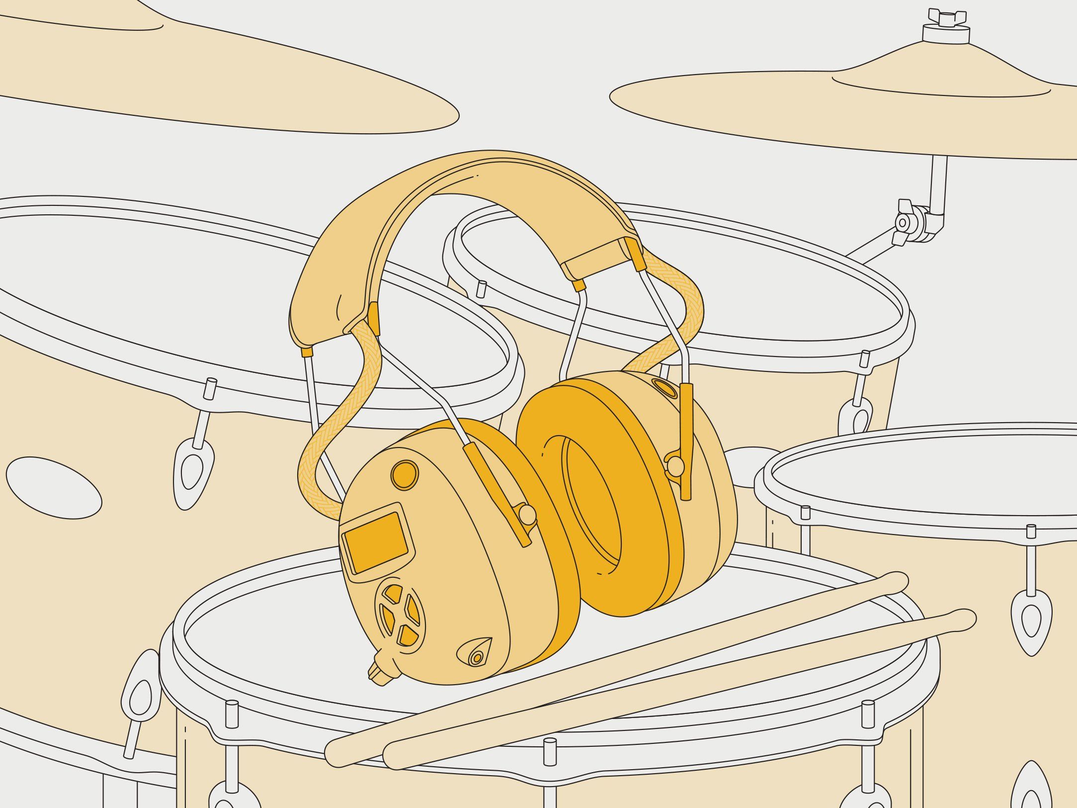 A pair headphones sitting on a drum set with embedded microphones on each side.