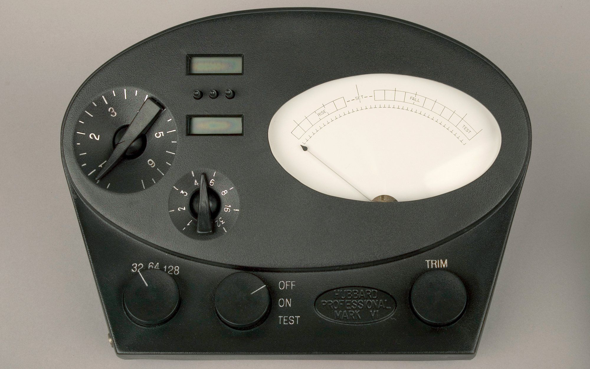 Photo of an electrical device with an oval meter and several dials.