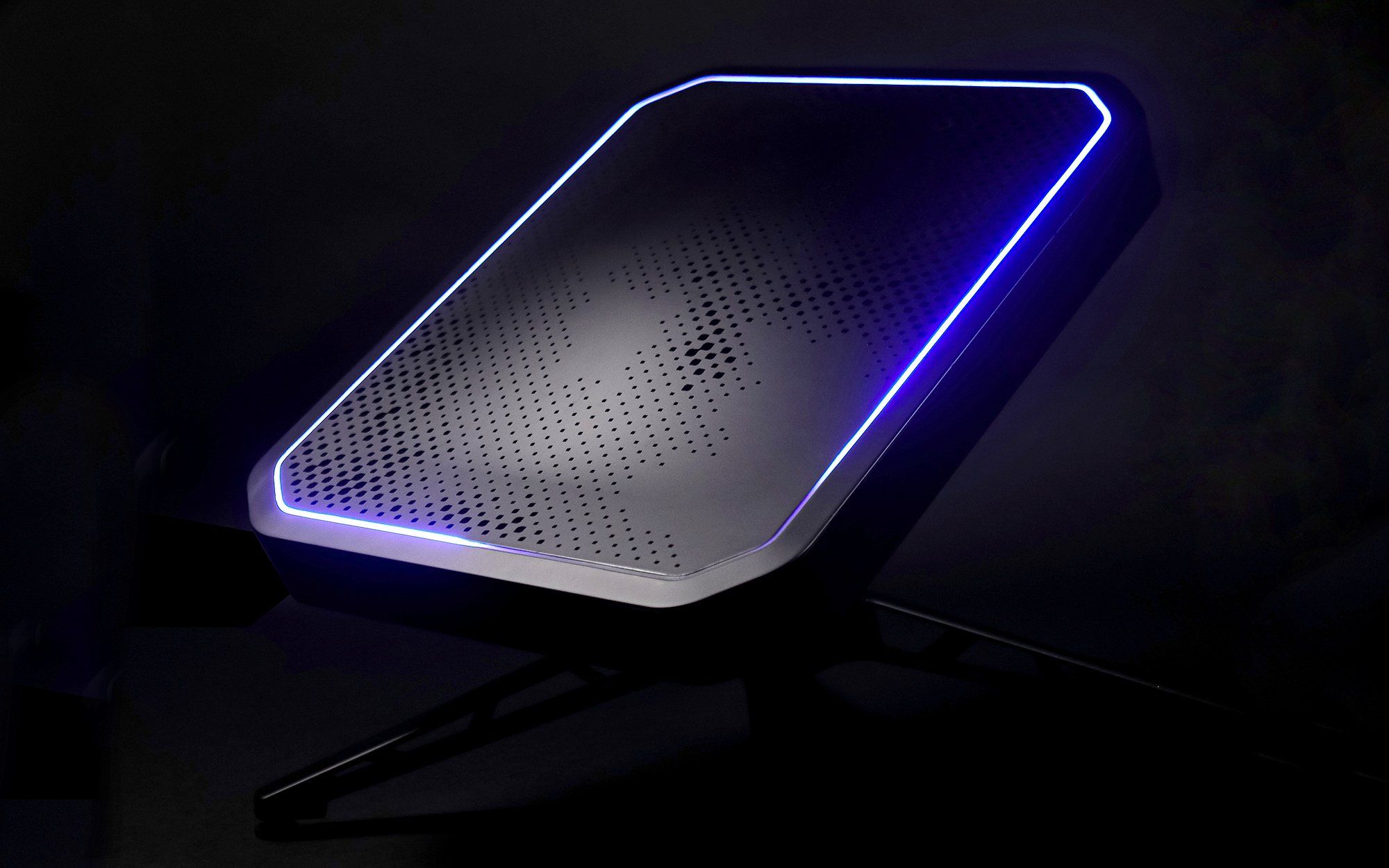 Greenerwave's satellite internet ground terminal with a reconfiguarable intelligent surface is a rectangle with glowing lights on the perimeter and many dot, square, and diamond shapes on its surface.