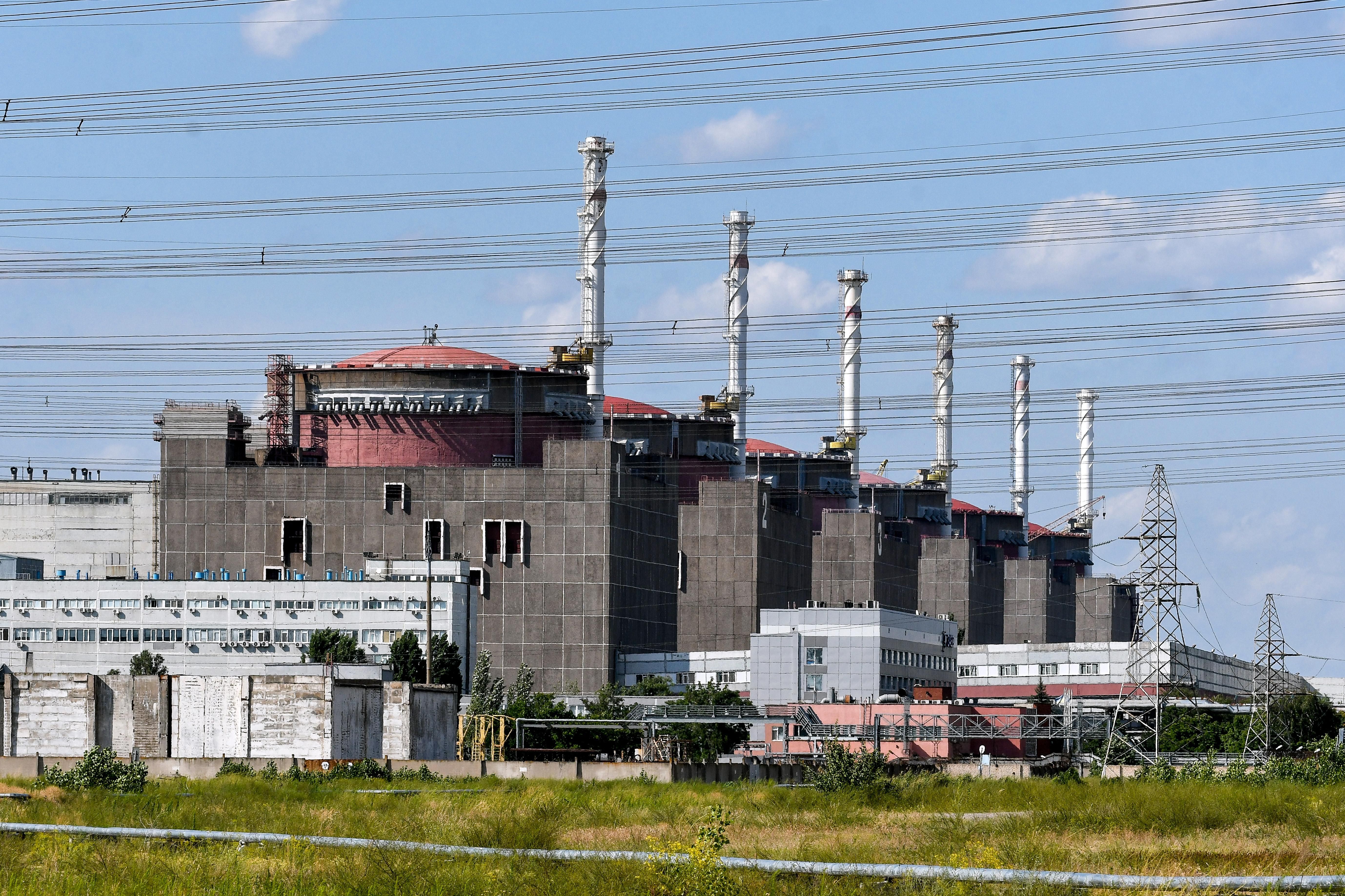 Power lines in front of 6 red reactors in concrete buildings