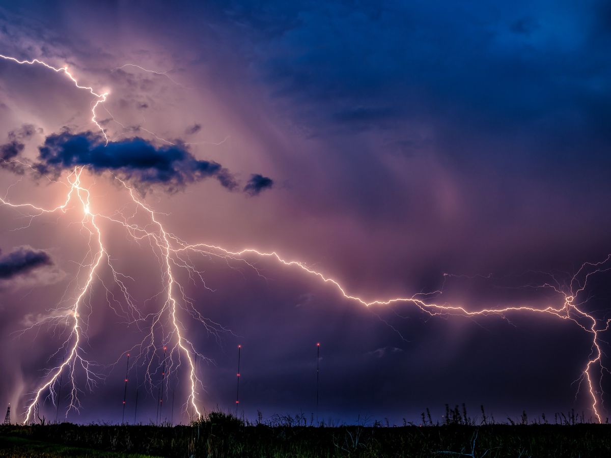 lightning bolts stretching across a dark cloudy sky