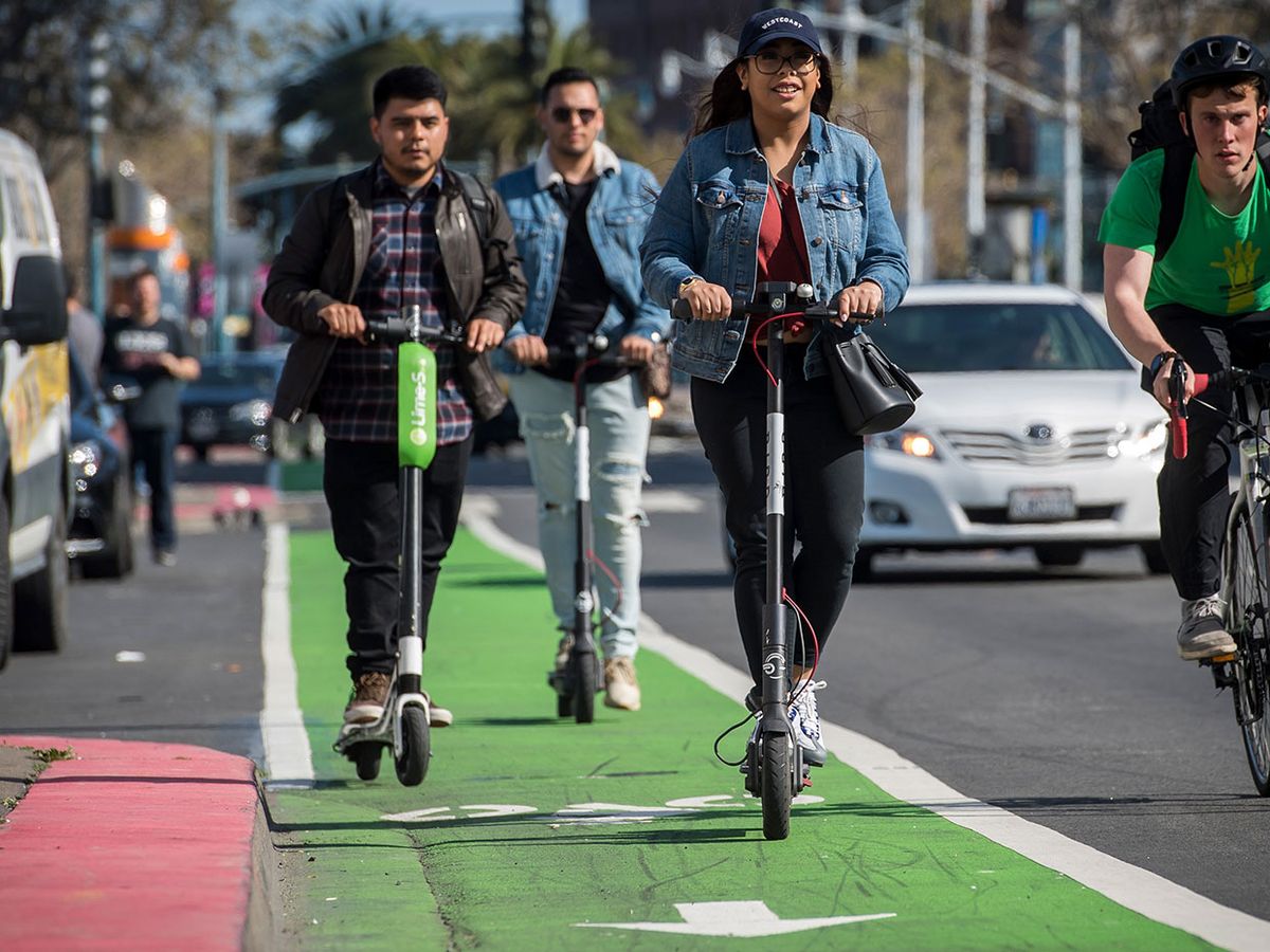 LimeBike (left) and Bird Rides shared electric scooters on the Embarcadero in San Francisco, California, U.S., on April 13, 2018.