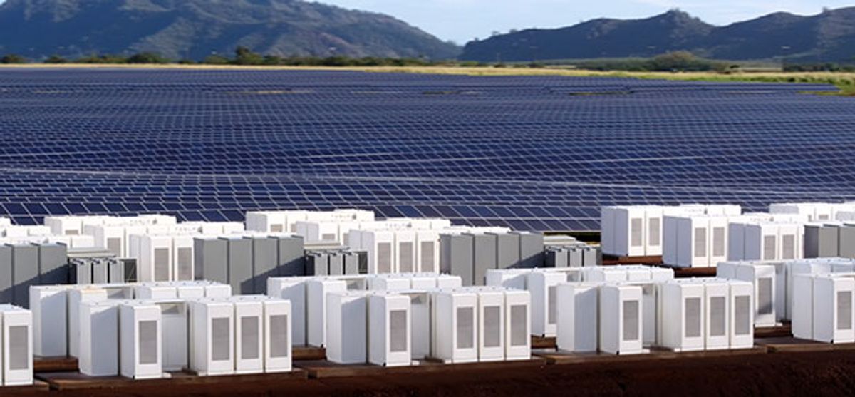 Lithium-ion energy storage units stand in front of an array of solar photovoltaic panels in Hawaii.