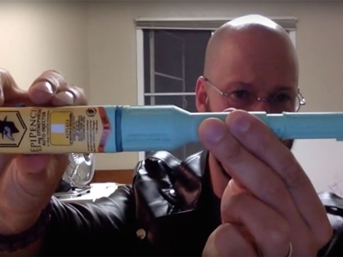 Man holds up a DIY version of the EpiPen autoinjector