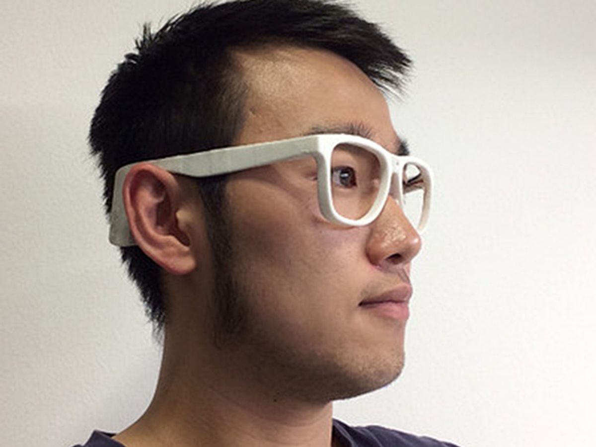 Man wearing white plastic glasses made via 3-D printing