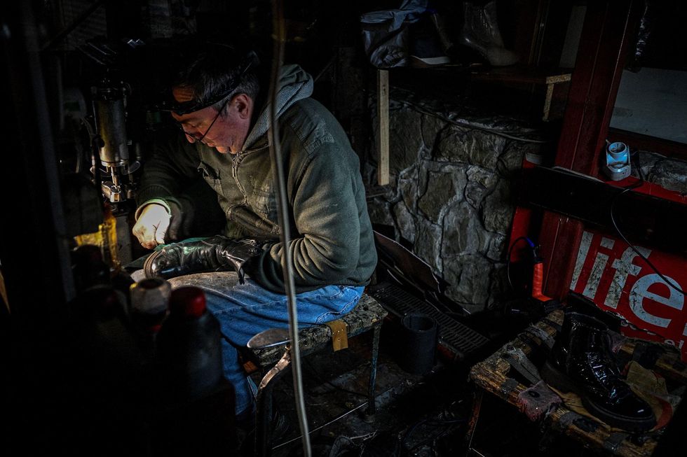 man working under a headlight in the dark