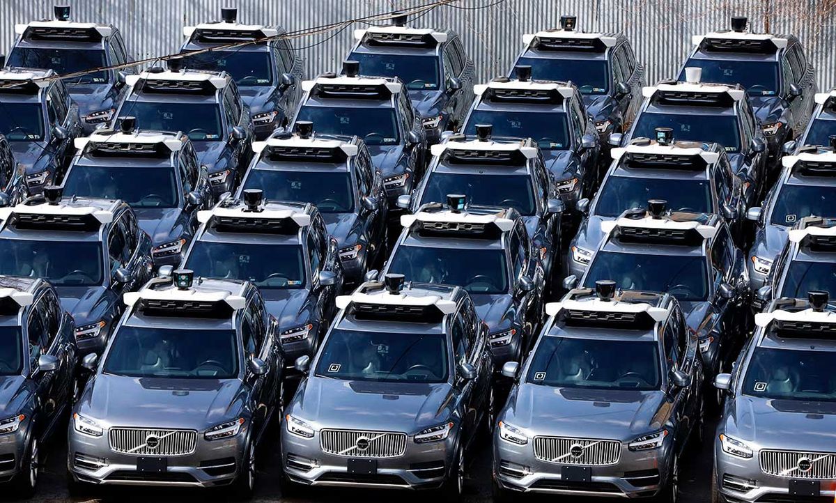 March 20, 2020 photograph shows a parking lot full of Uber self-driving Volvos in Pittsburgh.