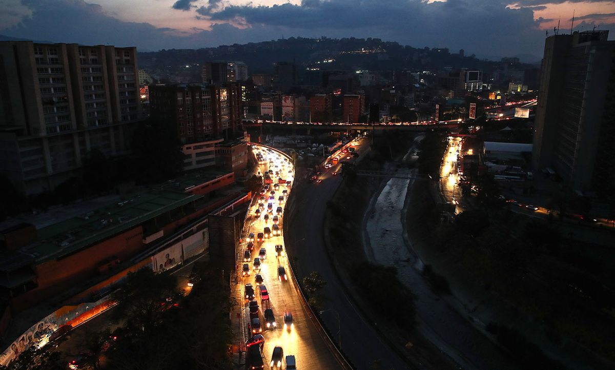 March 9th, 2019 aerial photograph of Caracas, Venezuela showing dark streets lit by car headlights during power outage.