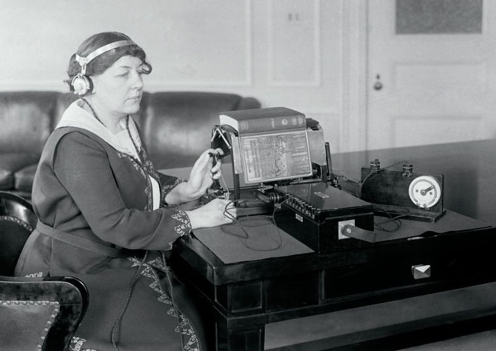 Margaret Hogan used the black sounding optophone to read a book.