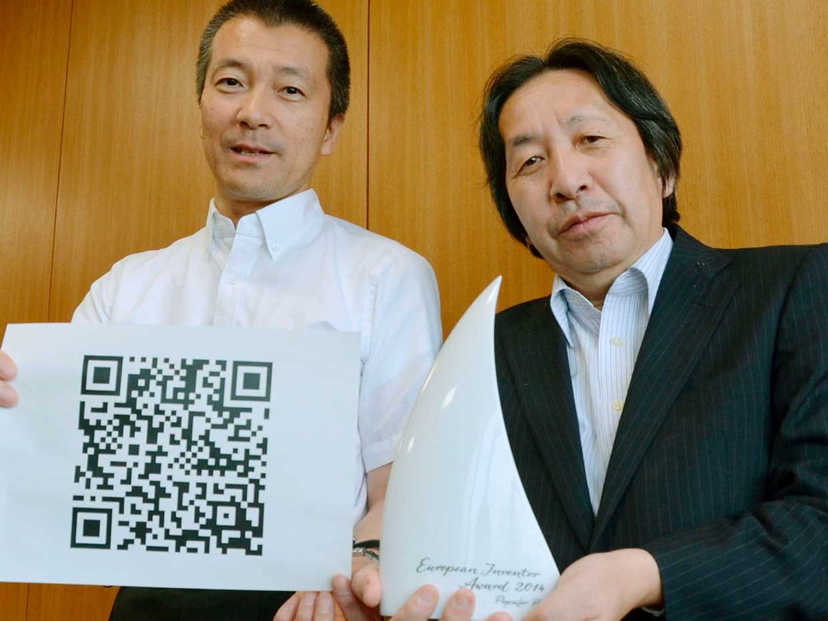 Masahiro Hara (R) of Denso Wave Inc. and Takayuki Nagaya of Toyota Central R&D Labs. Inc. show their Popular Prize awarded by the European Patent Office for their invention of the square "Quick Response Code," or QR code.
