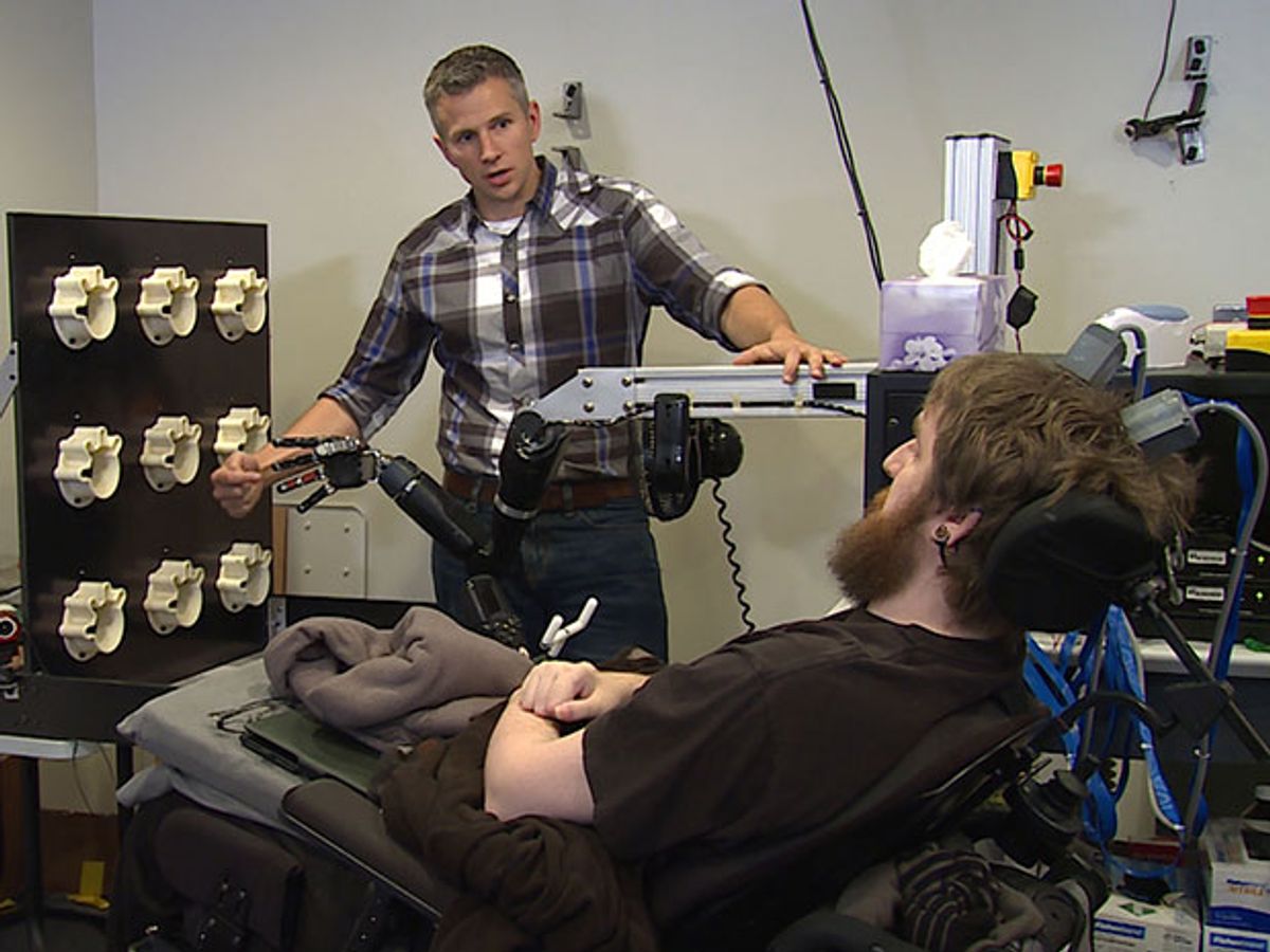 Nathan Copeland participating in an experiment where a robotic hand is pressed and he feels the sensation of touch