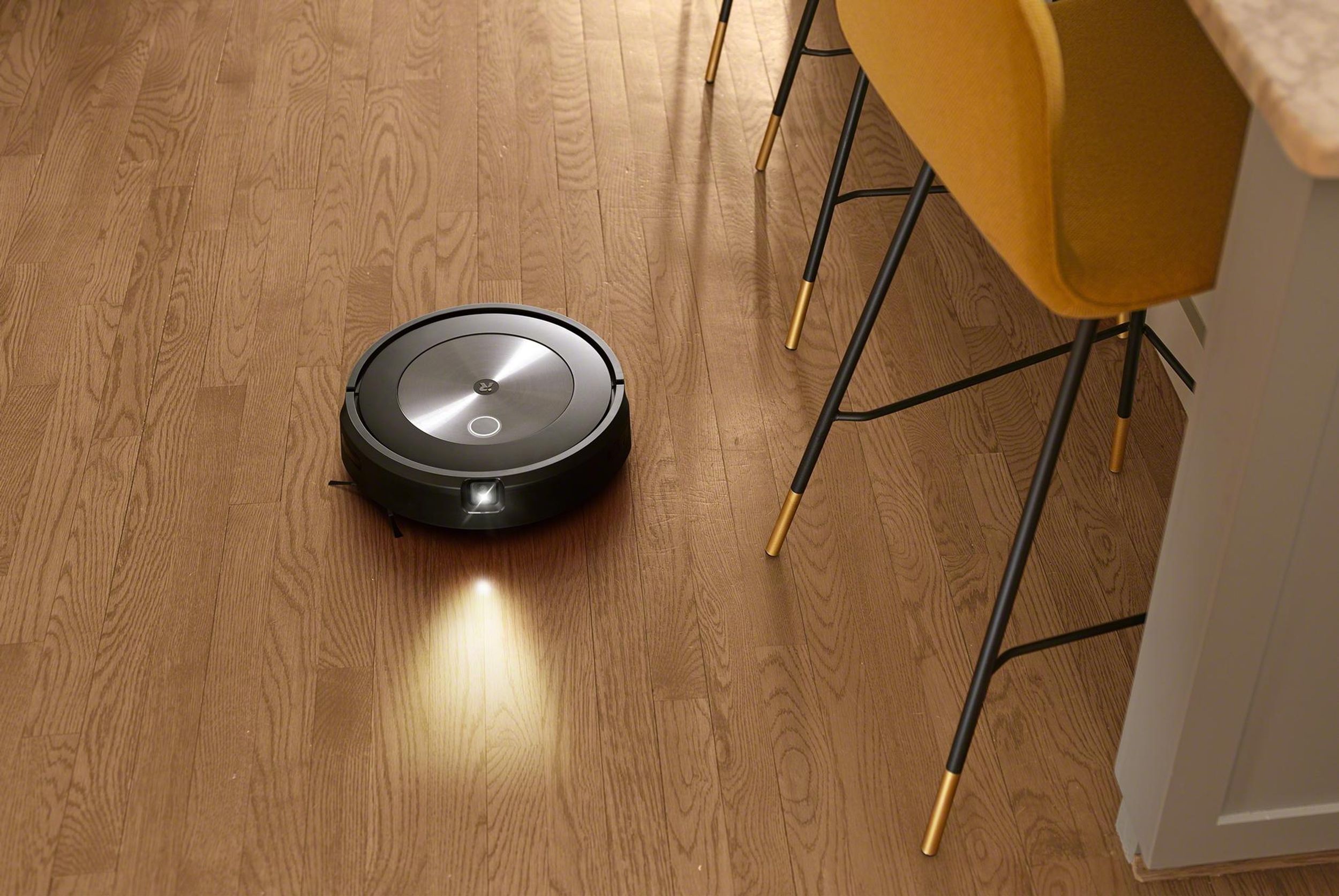 New iRobot j7 with front-facing camera and led light vacuuming a kitchen floor