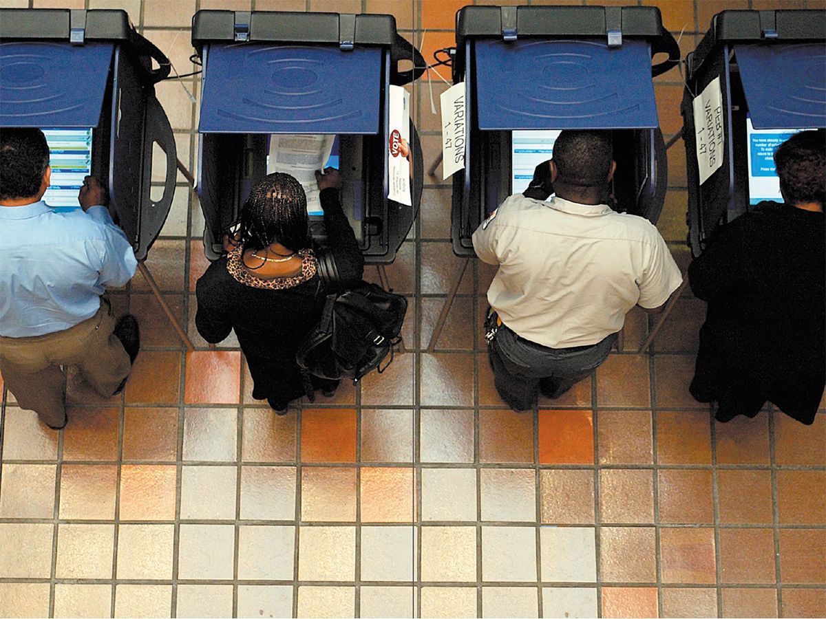 Overhead shot of people voting in voting booths.