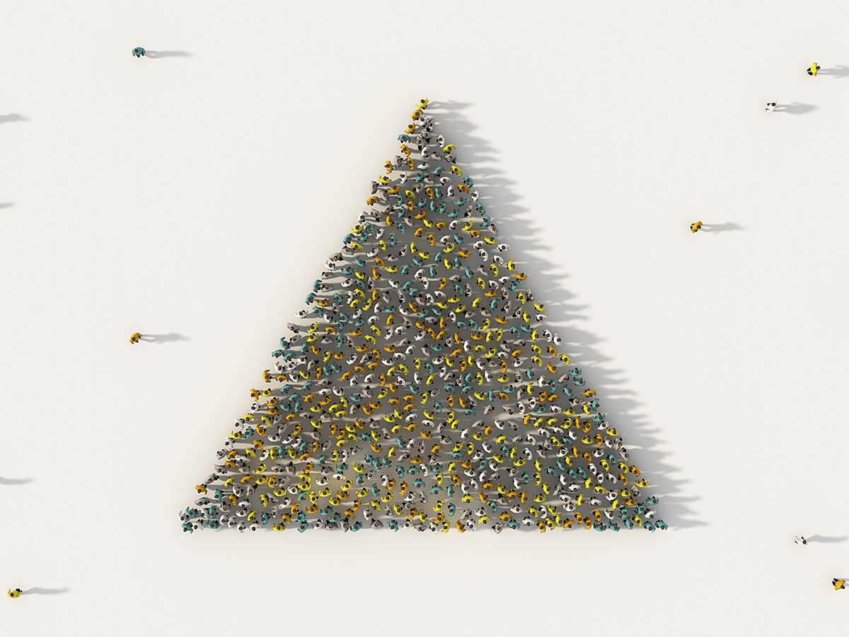 Overhead view of people standing to form pyramid shape.