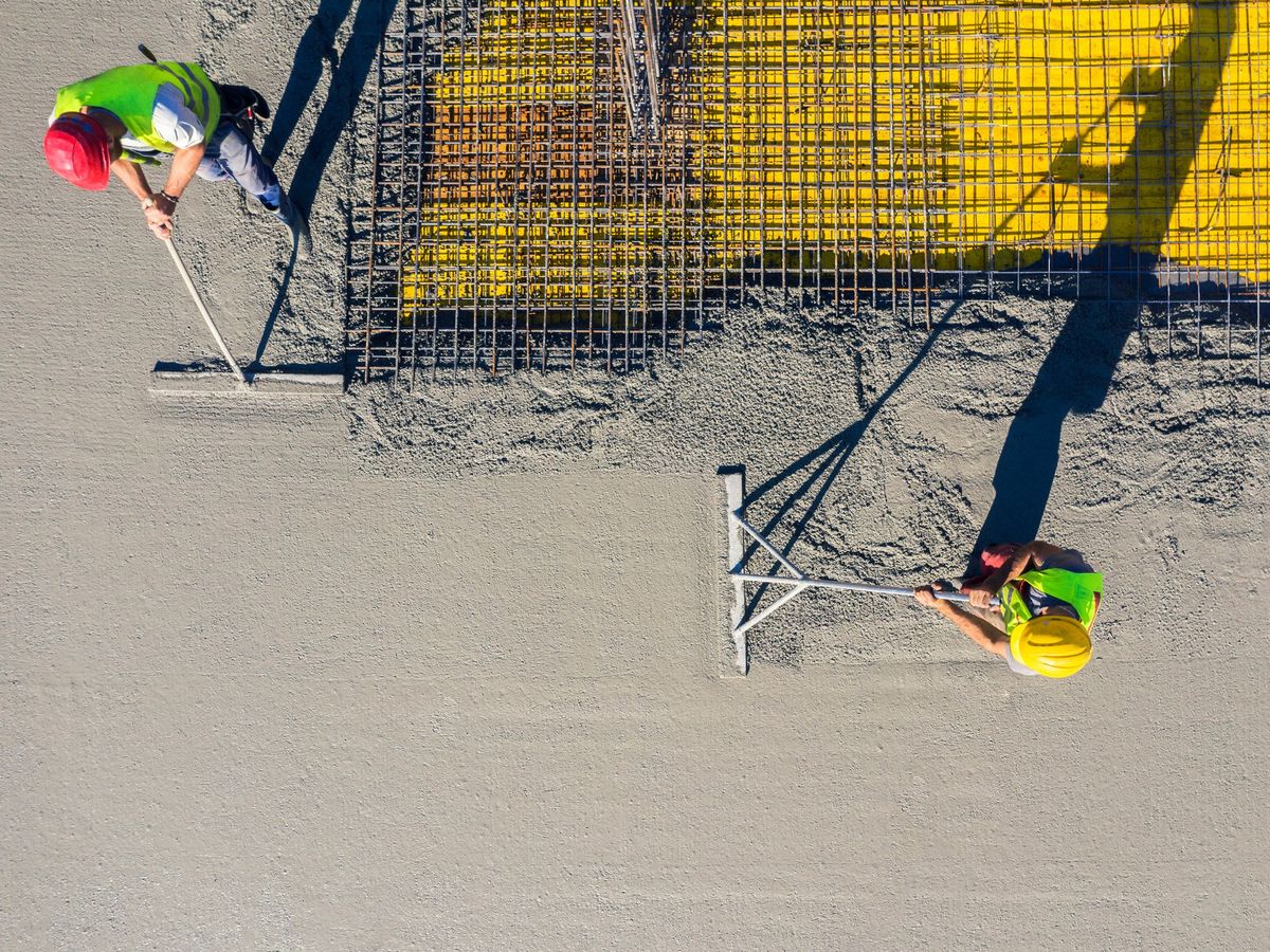 overhead view of workers smoothing over concrete slab