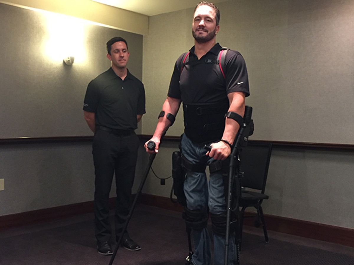 Paraplegic user stands and walks with the help of the Ekso GT, a robotic exoskeleton. 