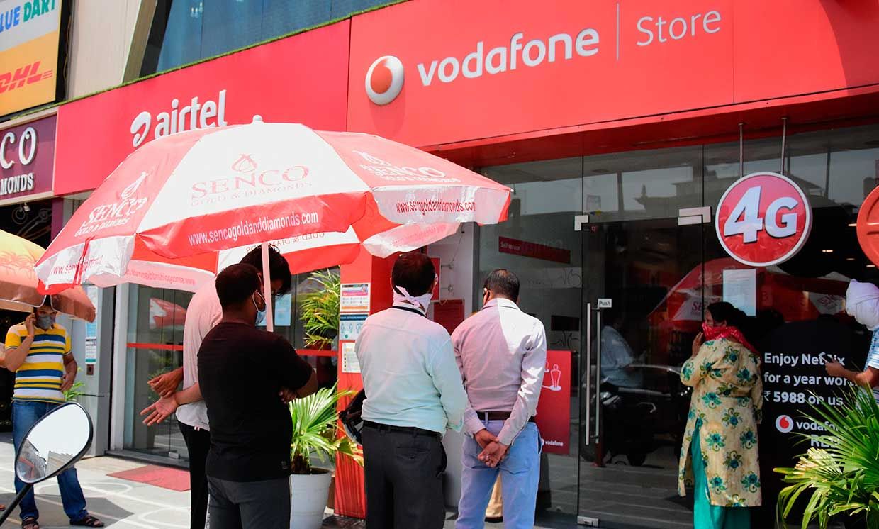 People at a Vodafone store queue at a social distance due to COVID-19 precautions, May 19, 2020 in Delhi, India.