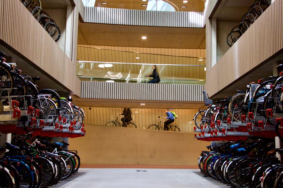 People ride bicycles at Stationsplein Bicycle Parking facility located near Utrecht Central Station in Utrecht, Netherlands