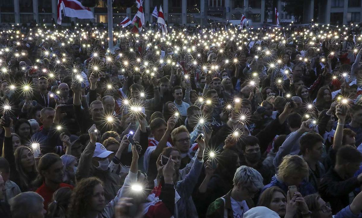 People use their mobile phone torches during an opposition rally in Minsk, Belarus