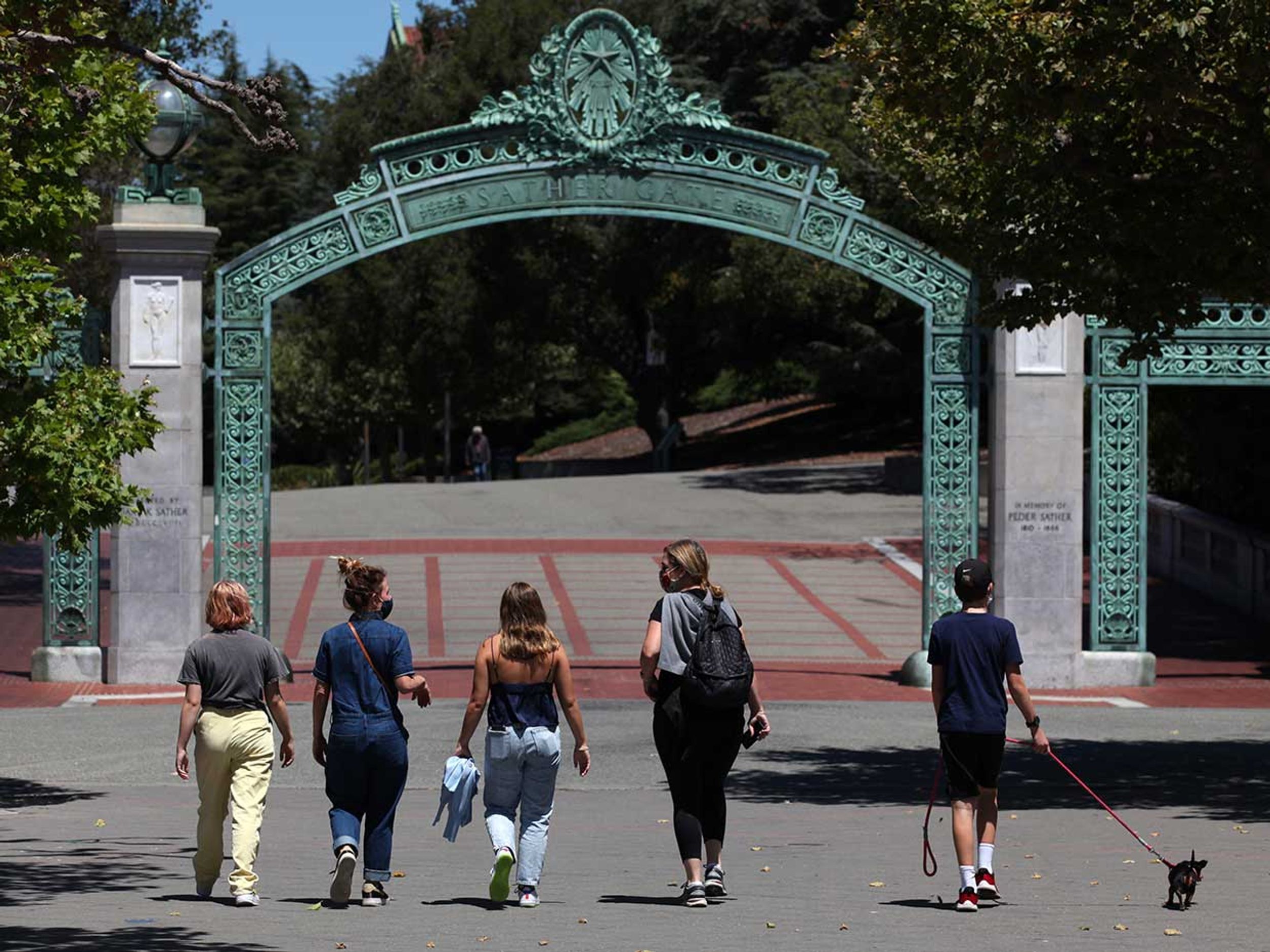 People walk towards Sather Gate on the U.C. Berkeley campus on July 22, 2020 in Berkeley, California.