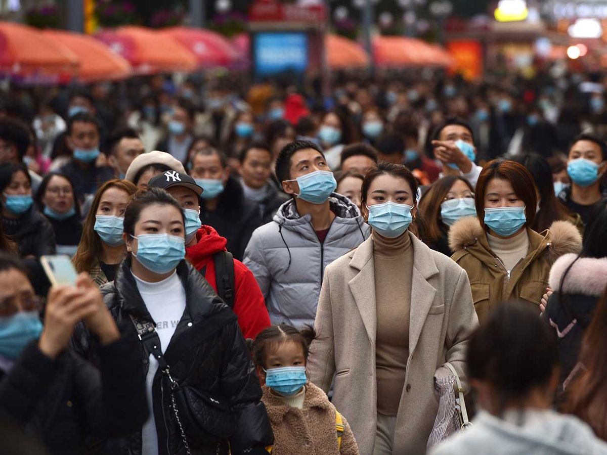 People wearing face masks visit Chunxi Road, the busiest commercial pedestrian Street in Chengdu, China, on November 28, 2020.