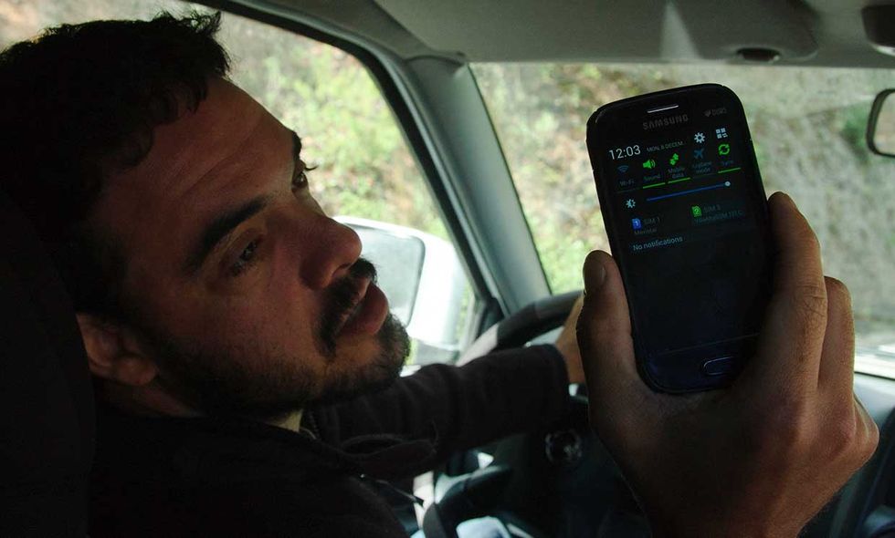 Peter Bloom of Rhizomatica shows off the signal strength on a handset outside of Talea de Castro, Mexico. December 2014.