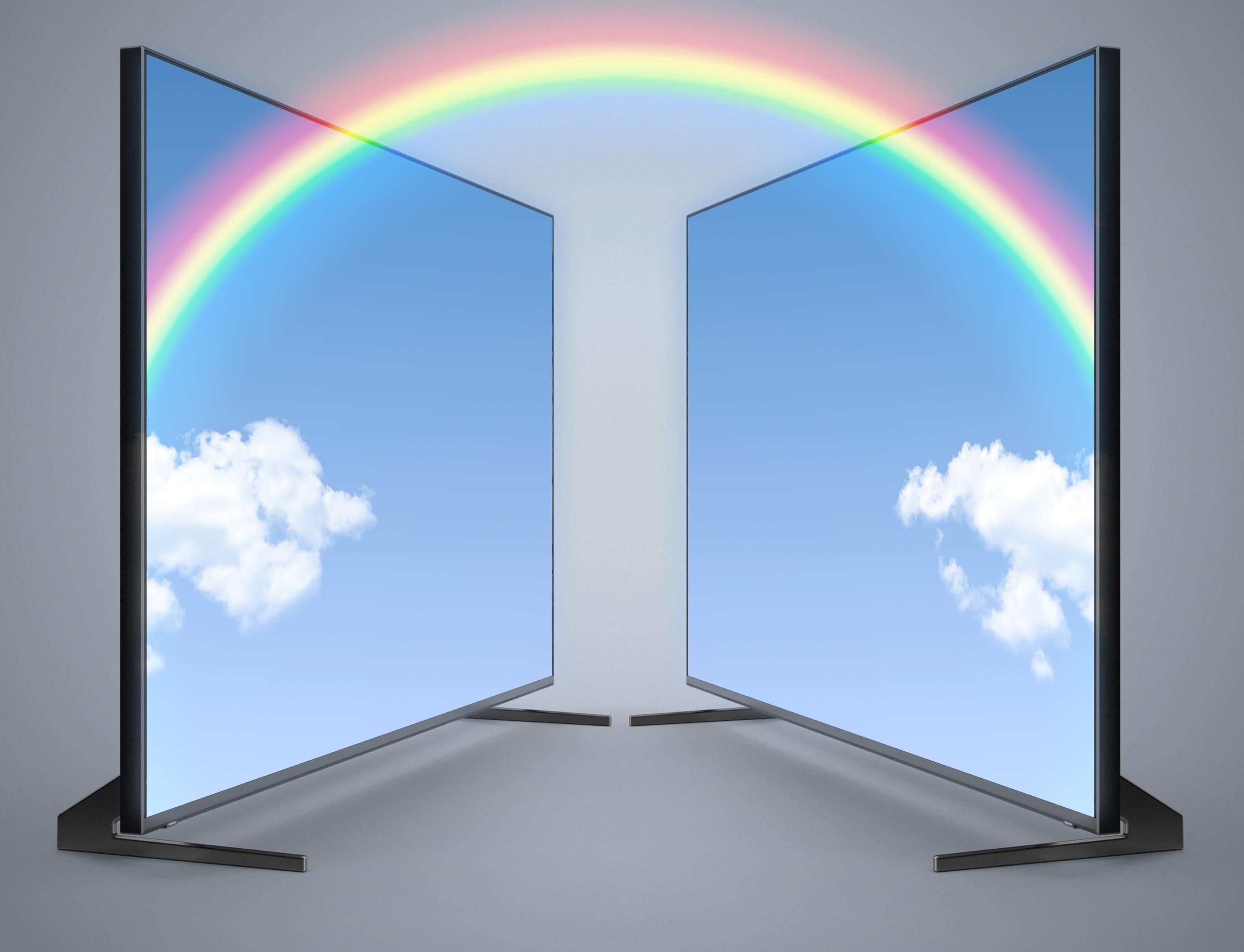 Photo illustration of 2 display monitors facing each other connected by a rainbow