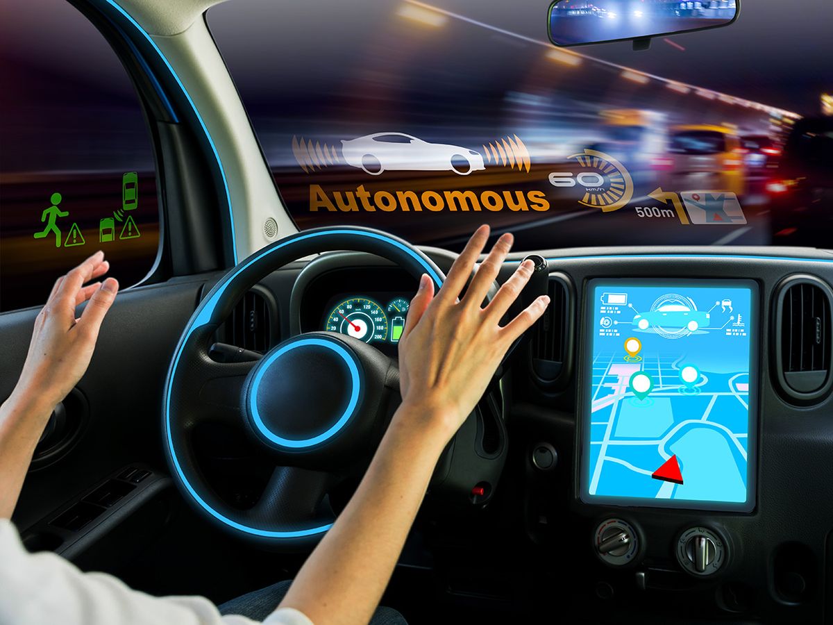 Photo-illustration of an autonomous car with the driver about to engage with the wheel.