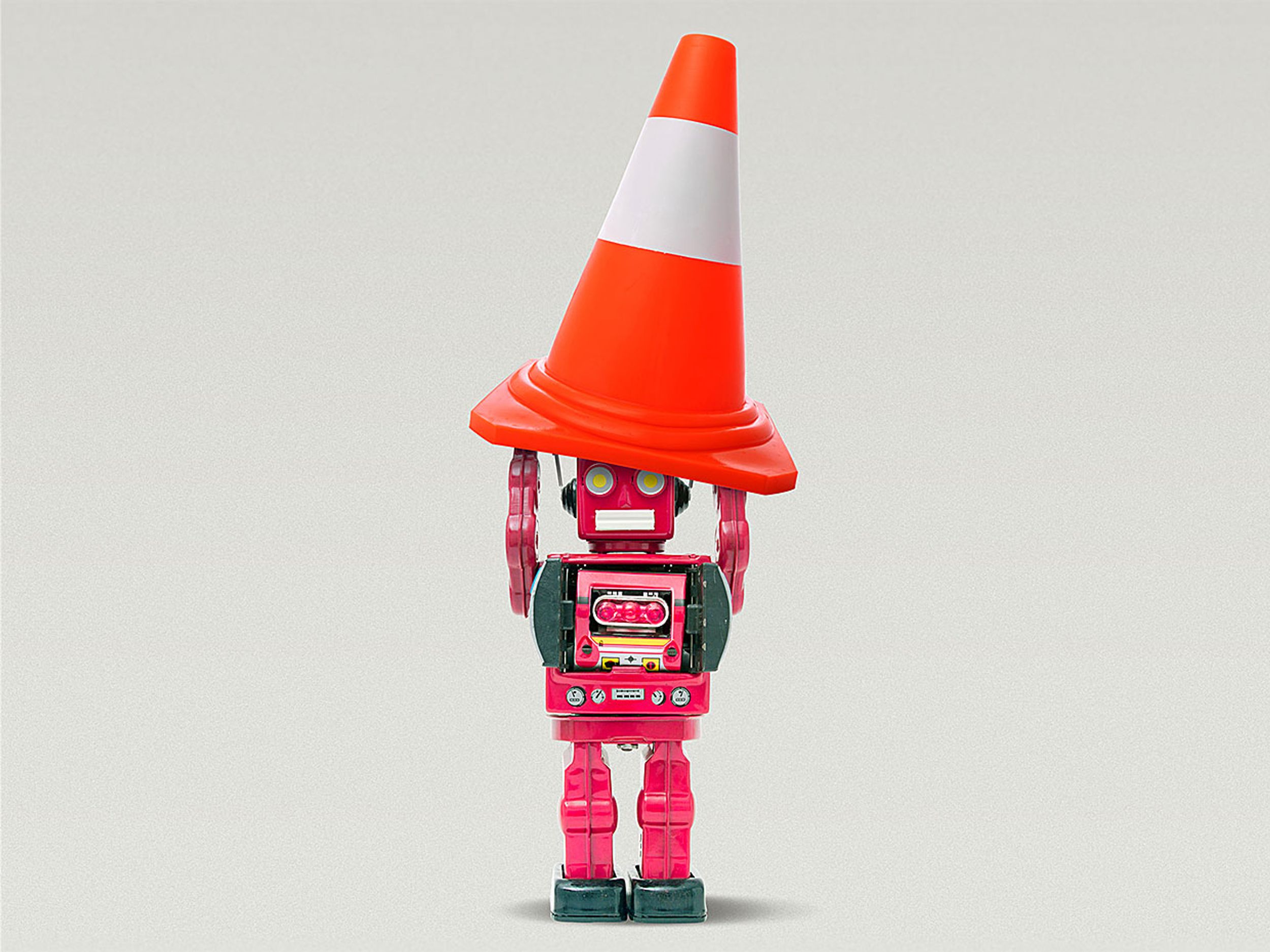 Photo-illustration showing a robot holding a traffic cone.