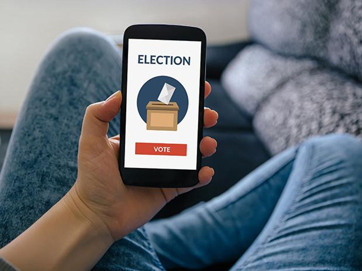 Photo of a person holding a cellphone and the word “ELECTION” and a button that says “VOTE.” 