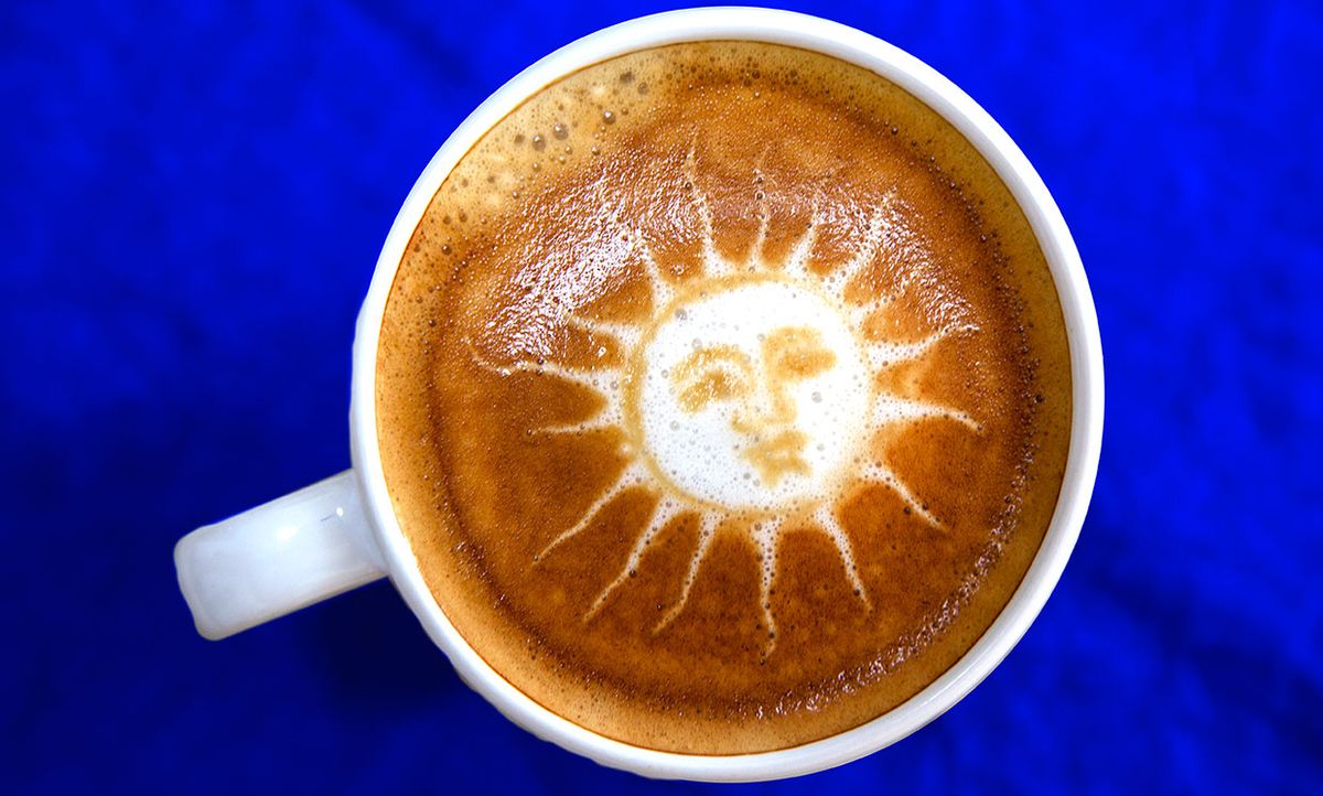 Photo of a sun design in a cup of coffee.