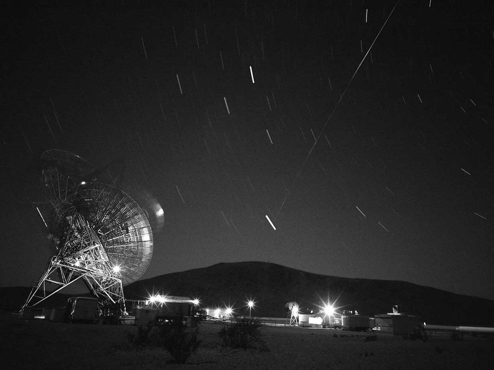 Photo of a tracking station and the night sky.  