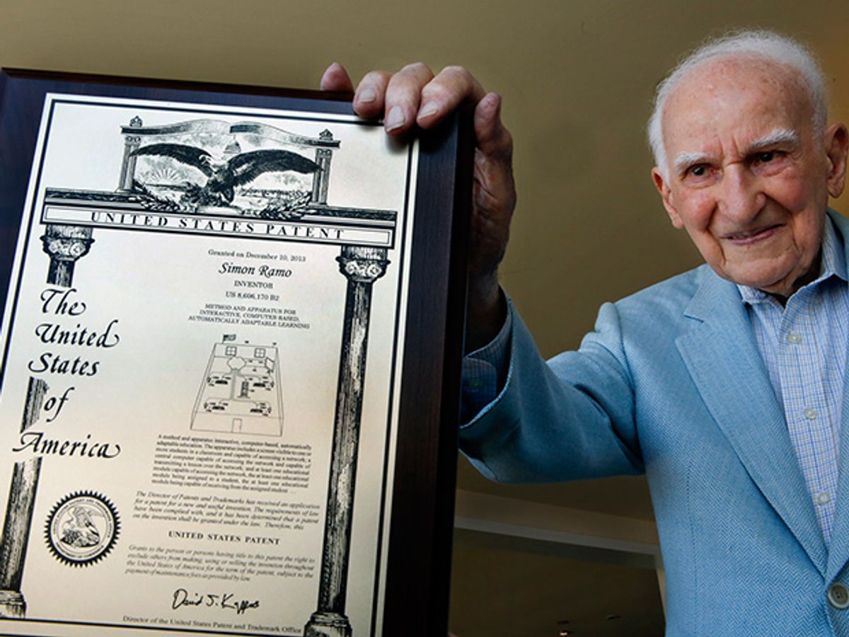 Photo of Mel Melcon holding the patent.