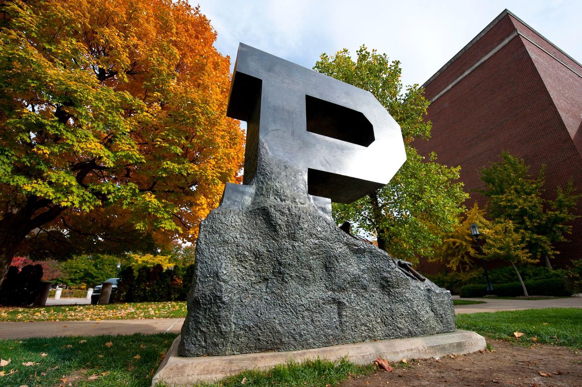 Photo of Purdue campus showing a sculpture of a rock topped with a large metal P letter.