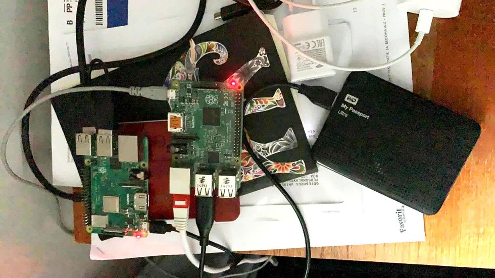 photo of Raspberry Pi with tangles of cables snaking around a number of peripherals, including a portable hard drive 