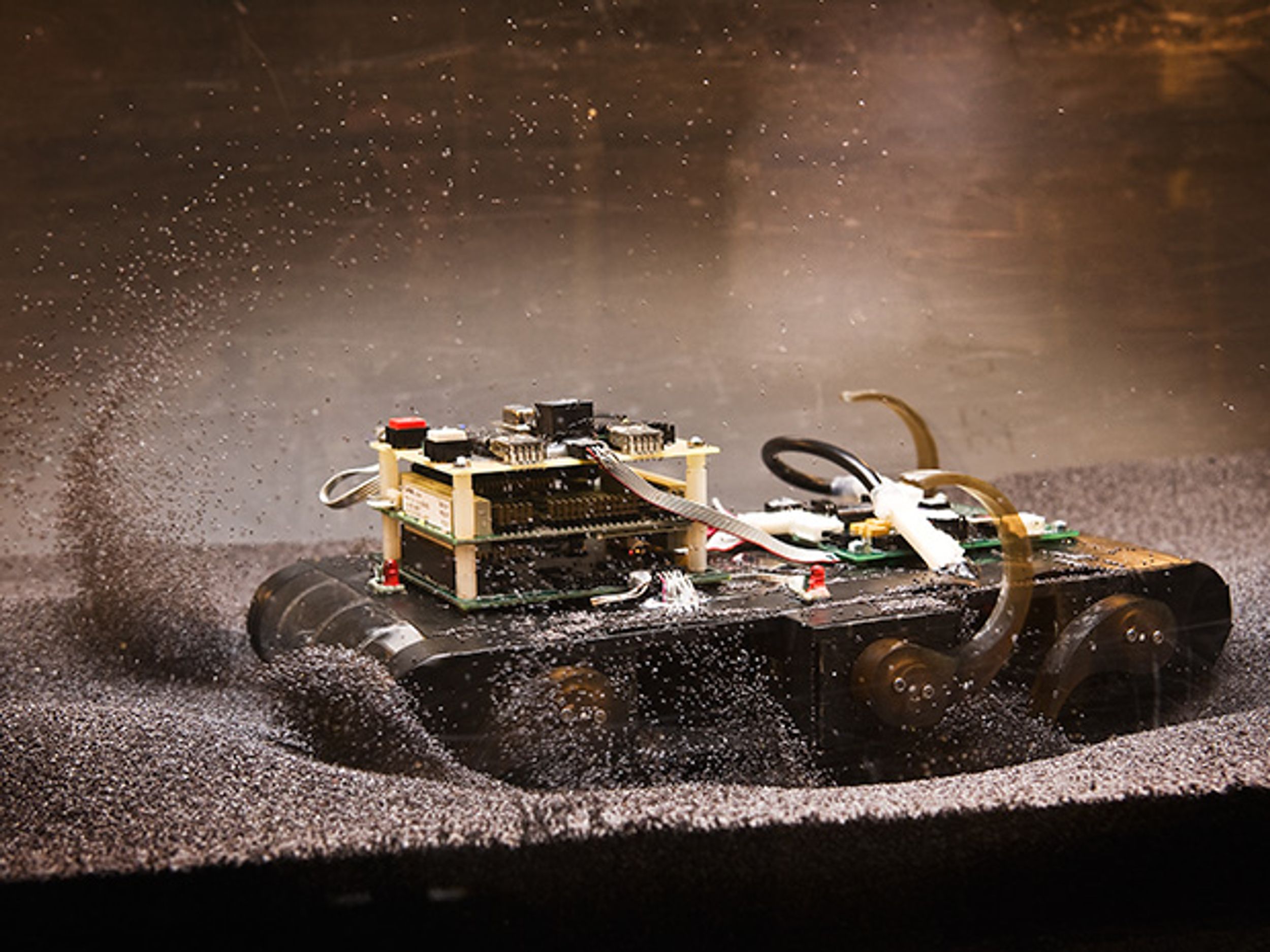 Photo of Sandbot as it trundles down a track filled with poppy seeds.