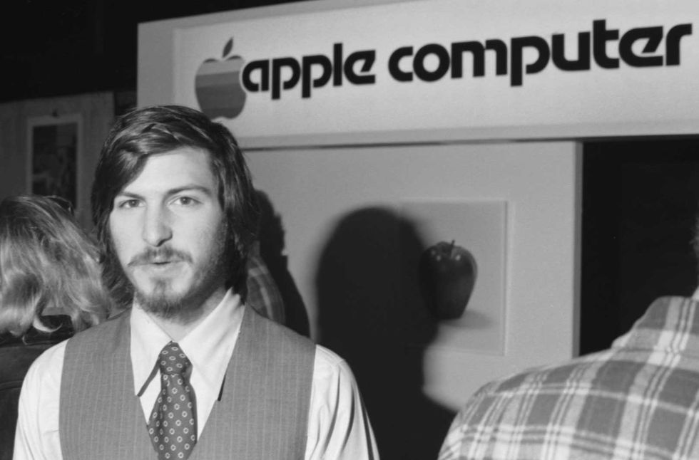 Photo of Steve Jobs in front of an Apple Computer sign