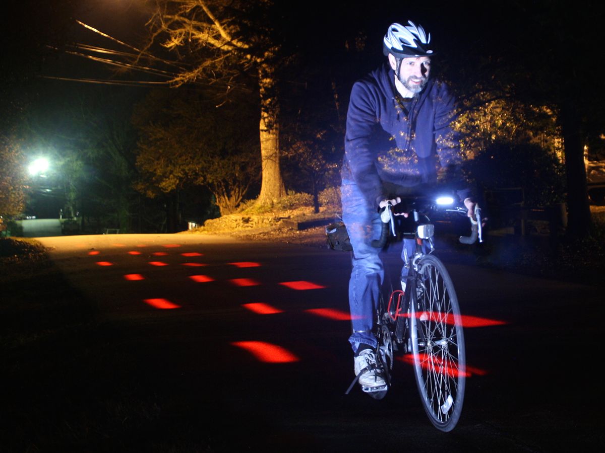 Photo of the author cycling at night.