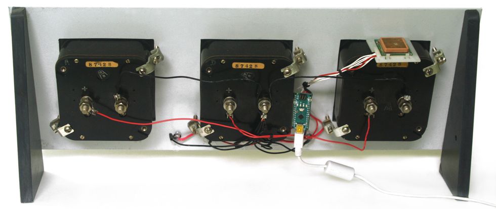 Photo of the back of the three mounted voltmeters on a rack panel.
