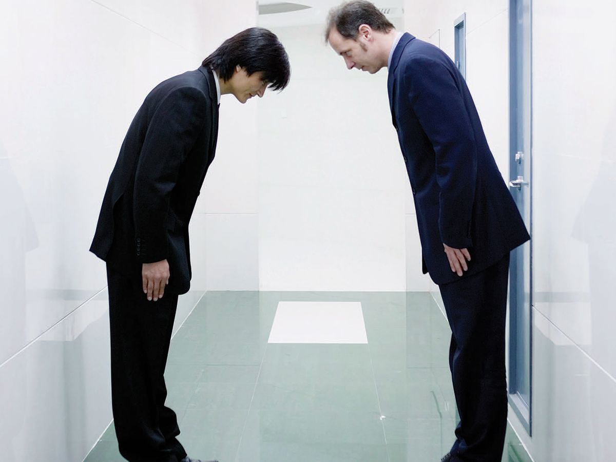 photo of two men bowing