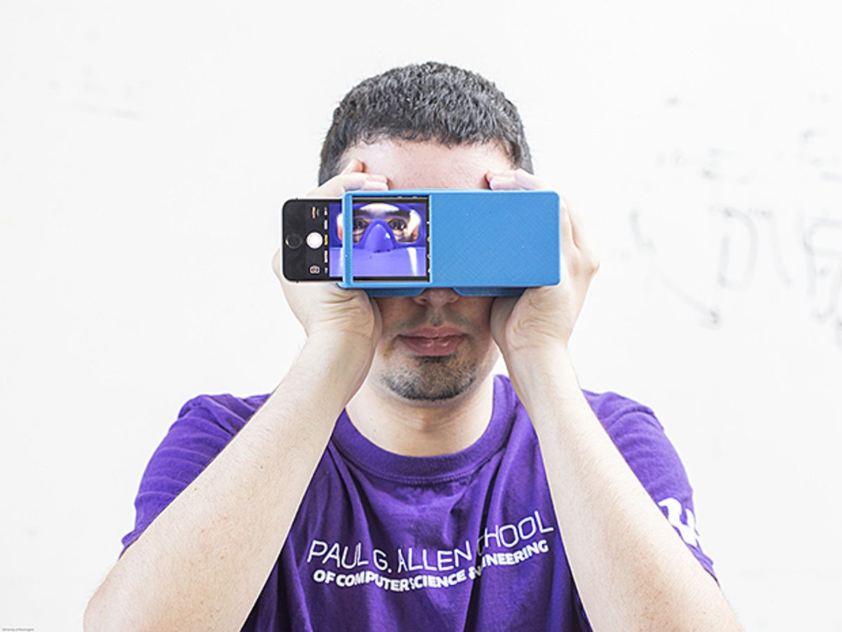 photo: Person holds up a box with smartphone camera facing his face to take a selfie of his eyes to detect early signs of pancreatic cancer via a new app